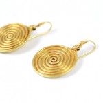 A pair of gold earrings with spiral design.