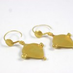 A pair of gold earrings with a square design.