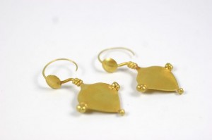 A pair of gold earrings with a square design.