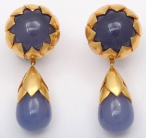 A pair of gold and blue earrings with a drop.