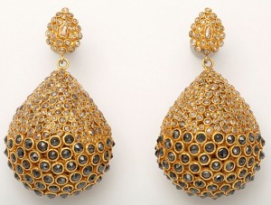 A pair of gold earrings with large, round stones.