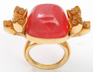 A red ring with gold and diamond accents.