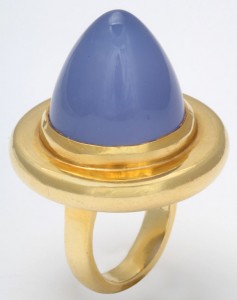 A gold ring with a blue stone on top of it.