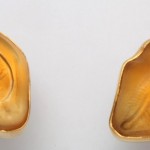 Two pictures of a peanut shell on the left and right side.