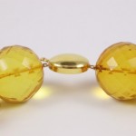 A close up of the yellow beads on a necklace