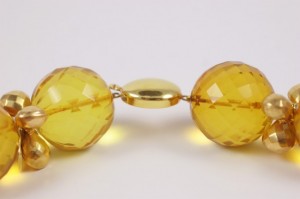 A close up of the yellow beads on a necklace
