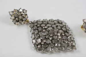 A close up of the earrings on a white surface