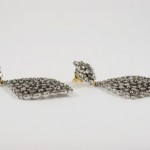 A pair of earrings with a diamond shaped design.