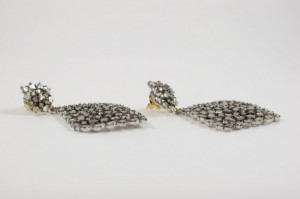 A pair of earrings with a diamond shaped design.