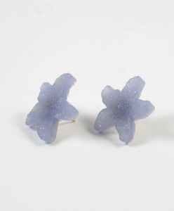 A pair of earrings made out of plastic.