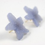 A pair of earrings made out of blue sea glass.