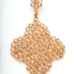 A gold necklace with white stones on it