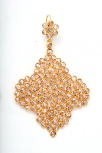 A gold necklace with white stones on it