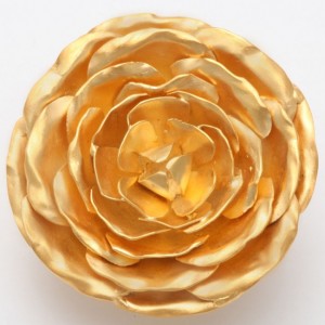 A gold flower is sitting on top of the table.
