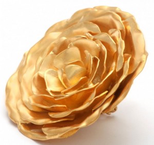 A gold flower is sitting on top of the table.