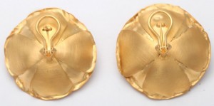 A pair of gold earrings with a swan on the top.