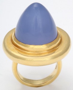 A gold ring with a blue stone on top of it.