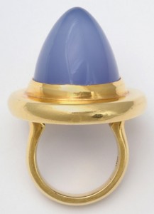 A gold ring with blue stone on top of it.