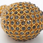 A close up of the gold and black diamond ball