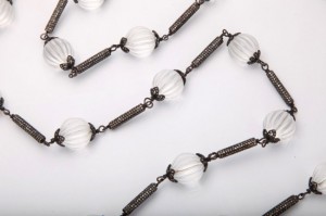 A close up of a chain with glass beads