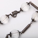 A close up of a necklace with clear beads