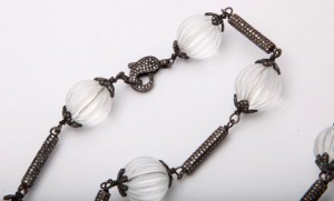 A close up of a necklace with clear beads