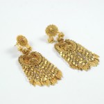 A pair of gold earrings with dangling chains.