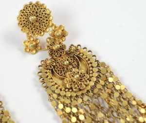 A close up of the earrings on a white background
