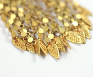 A close up of the gold leaf design on the necklace.