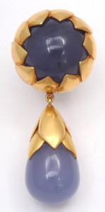 A pair of gold and blue earrings.