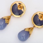 A pair of earrings with blue chalcedony and gold.