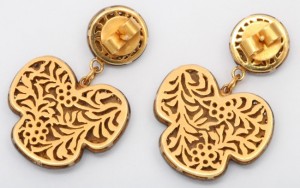 A pair of gold earrings with floral design.