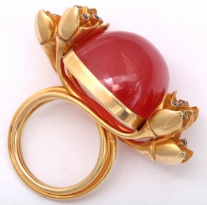 A red and gold ring with diamonds on it.