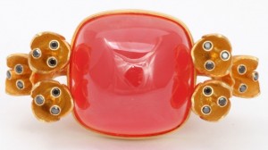 A close up of the side of a red and yellow bracelet