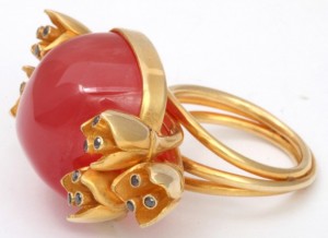 A close up of the ring with a red stone