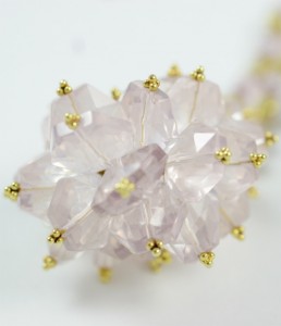 A close up of the flower shape of a necklace
