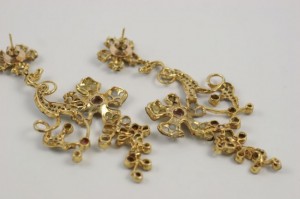 A close up of some gold jewelry on top of a table