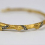 A close up of the side of a gold bracelet