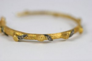 A close up of the side of a gold bracelet