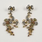 A pair of earrings with gold and silver beads.