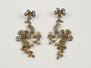 A pair of earrings with gold and silver beads.