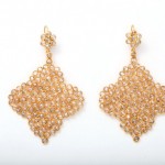 A pair of gold earrings with diamond shaped mesh.