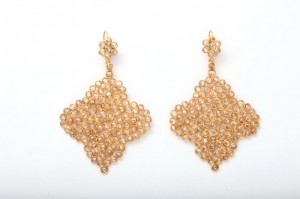 A pair of gold earrings with diamond shaped mesh.