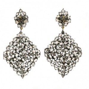 A pair of diamond shaped earrings with white stones.