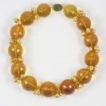 A necklace of yellow beads and gold spacers.