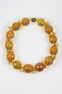 A necklace of yellow beads and gold spacers.