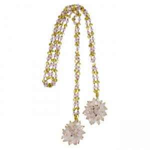 A long necklace with two flowers and beads.