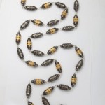 A long necklace of gold and black beads.