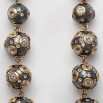 A long necklace with gold and silver beads