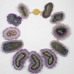 A necklace made of purple and green agate slices.